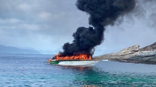 Dozens of tourists swam for their lives to escape a burning speedboat off the coast of Thailand this morning. The 33 holidaymakers and four Thai crew were sailing on the vessel, Tana Marine 555, from Phuket to Koh Mai Thon when it caught fire 50ft from the shore. They jumped overboard to escape the roaring flames and were rescued by a passing boat. Footage shows black smoke plumes billowing from the speedboat lodged between rocks as it was engulfed in flames. Nachapong Pranit, director of the Phuket Marine Office, said authorities deployed a rescue team after receiving a report at 9:20 am. Emergency responders arrived and found the passengers watching the wreckage burn from a distance. All 37 onboard the boat were taken to a hospital for treatment in Phuket. PACKAGE: Video, pictures, text