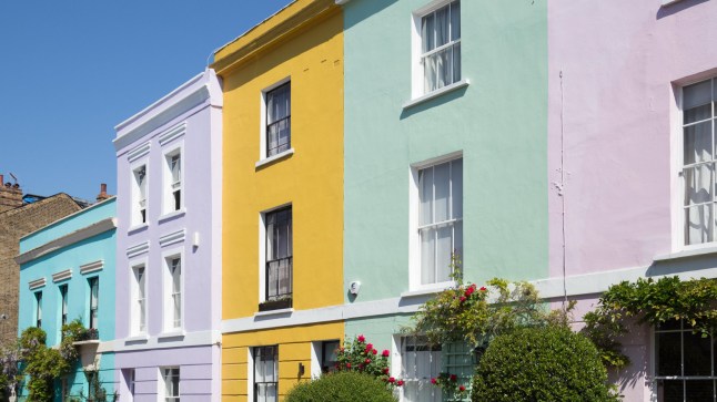 Colourfully painted terraced houses on Falkland Road in Kentish Town, North London.